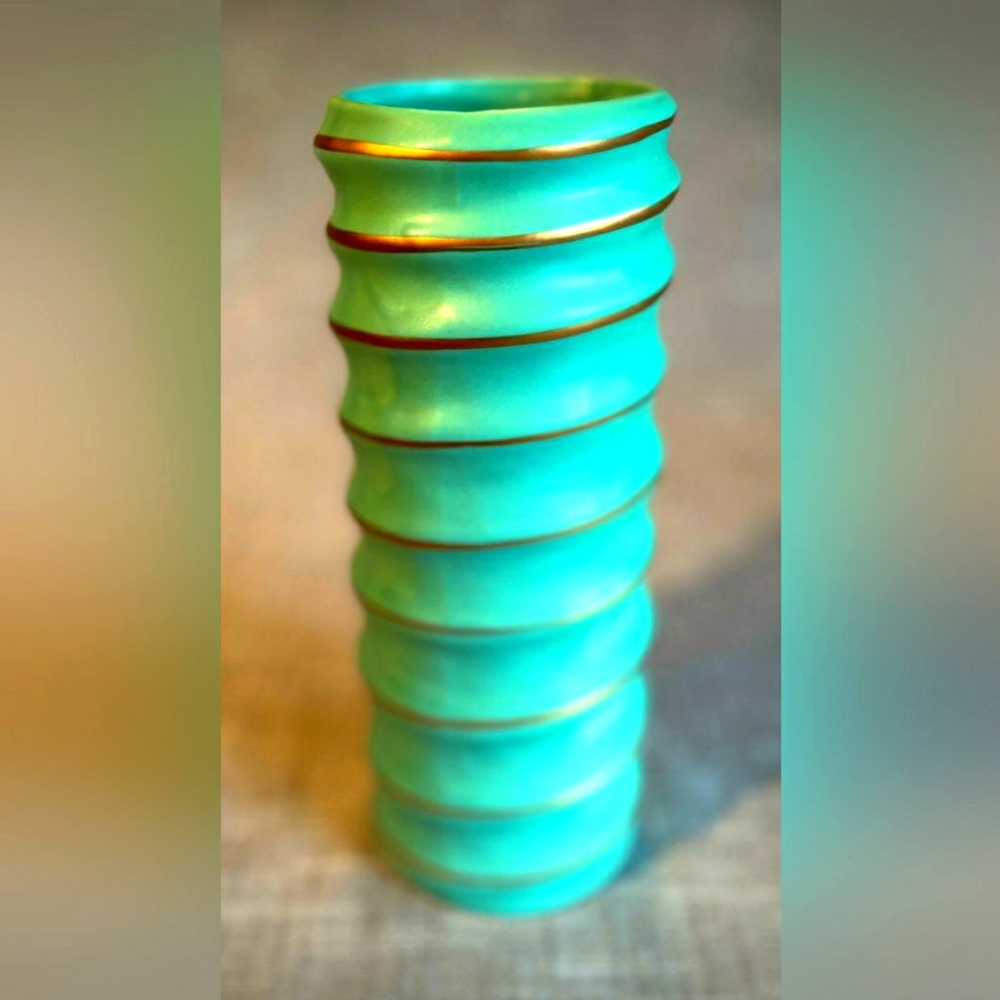 Turquoise flower vase with gold swirl.